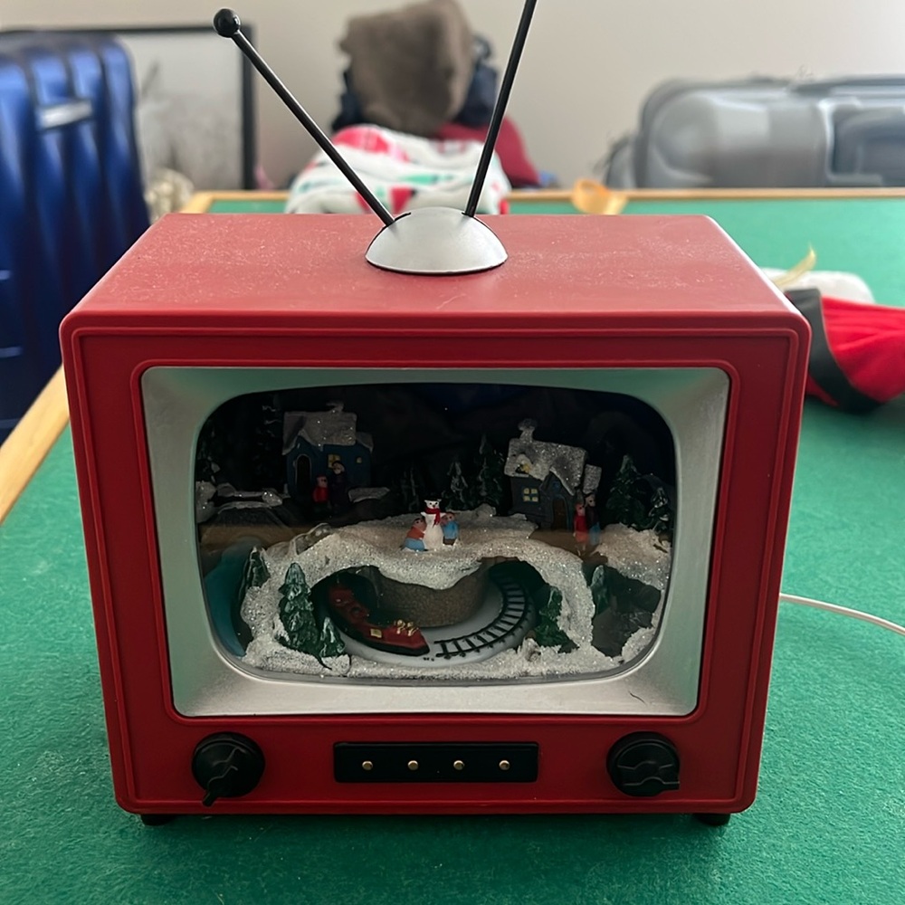 Christmas TV decorations in that moves,plays musics music, and lights up!